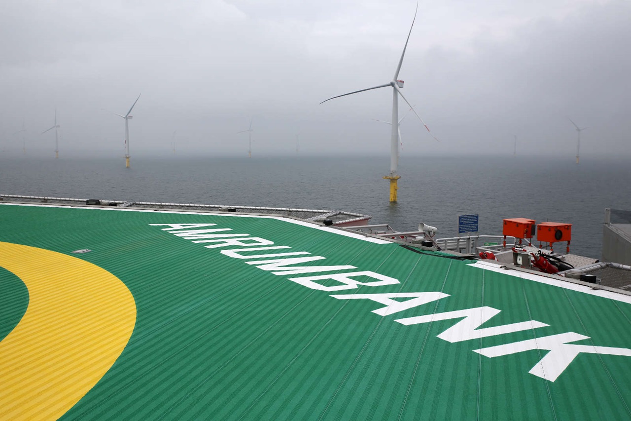 View of the offshore platform with wind turbines in fog. The ground reads 'AMRUMBANK'.
